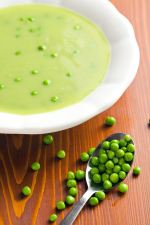pea soup in plate on kitchen tableの写真素材