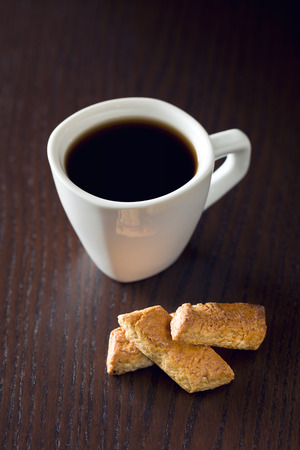 almond cookies and coffee on wooden tableの写真素材
