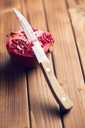 red pomegranate on wooden tableの写真素材