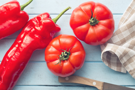red tomatoes and peppers on kitchen tableの写真素材