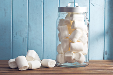 the white marshmallows on wooden tableの写真素材