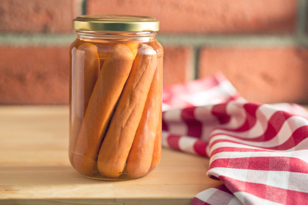 sausages in jar on kitchen table