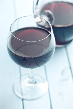 glass of red wine on kitchen tableの写真素材