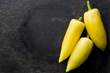 yellow peppers on black backgroundの写真素材