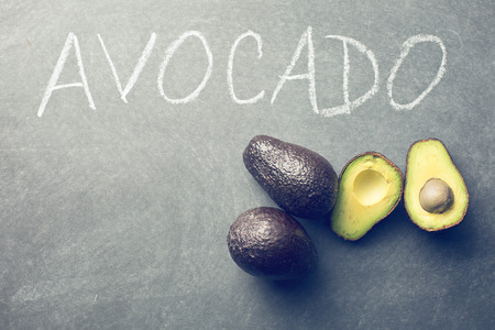 the halved avocado on blackboardの写真素材