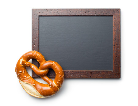 baked pretzel and chalkboard on white backgroundの写真素材