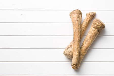 fresh horseradish root on kitchen tableの写真素材