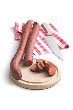 sliced dried sausages on white backgroundの写真素材