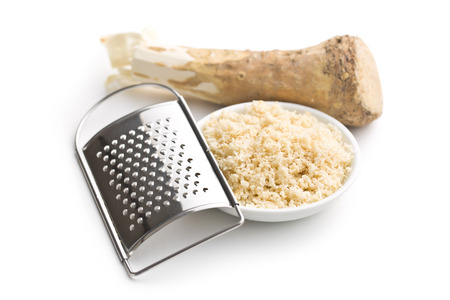 grated horseradish root on white backgroundの写真素材