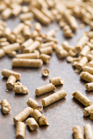 wooden pellets on old rusty backgroundの写真素材