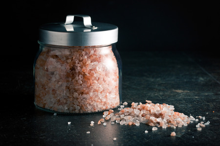 Himalayan salt in jar on kitchen tableの写真素材