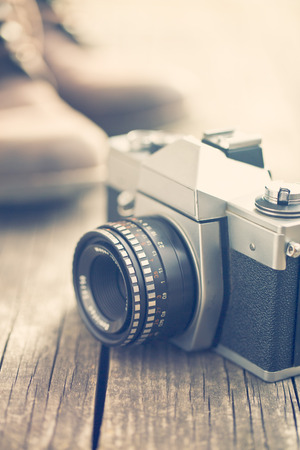 the retro analogue camera on old wooden tableの写真素材