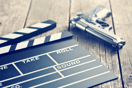 vintage photo shot of movie clapper and gunの写真素材