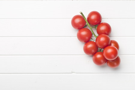 bunch of tomatoes on white tableの写真素材
