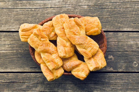 tasty baked bun on old table