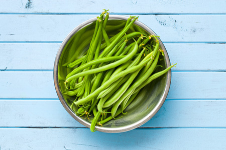 the green beans on blue kitchen table