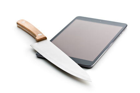 computer tablet and knife on white backgroundの写真素材