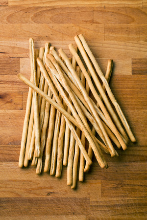 breadsticks grissini on old wooden table