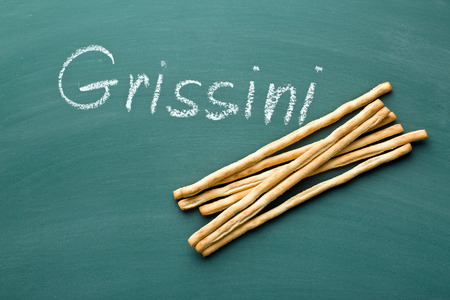 breadsticks grissini on chalkboardの写真素材