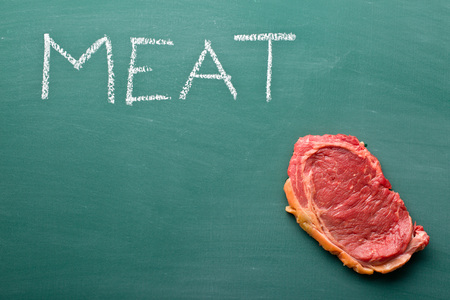 fresh raw beef on chalkboardの写真素材