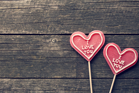 Lollipop heart on a vintage wooden backgroundの写真素材