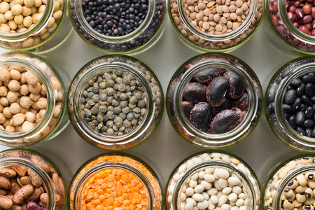 top view of various dried legumes in jarsの写真素材