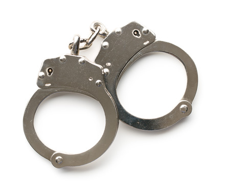 silver handcuffs on white backgroundの写真素材
