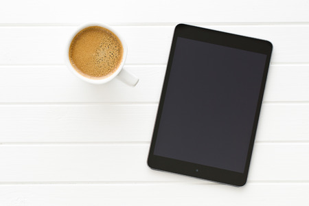 top view of coffee cup and computer tableの写真素材