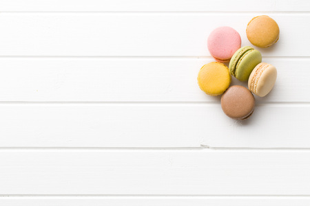 sweet french macarons on white kitchen tableの写真素材