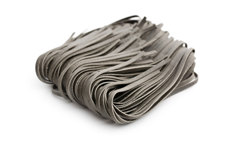 black noodles with squid sepia ink on white backgroundの写真素材