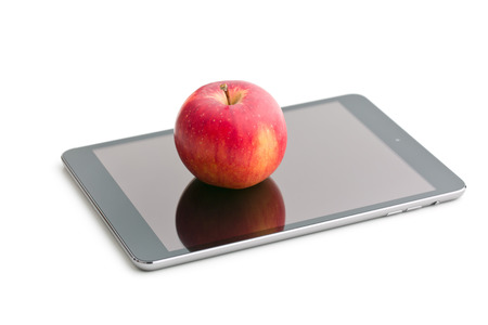 red apple and computer tablet on white backgroundの写真素材