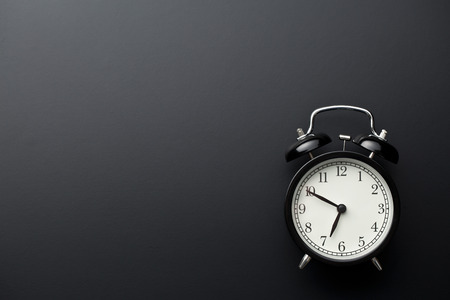alarm clock on black background