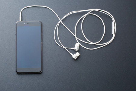 earphones and cellphone on black backgroundの写真素材