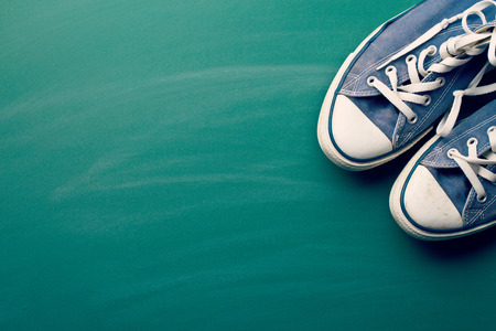 vintage sneakers on green chalkboardの写真素材