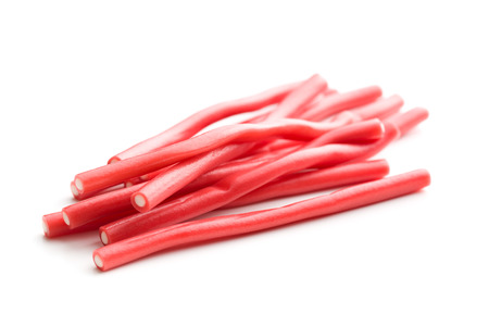 Sweet gummy sticks with strawberry and raspberry flavor. Tasty candies isolated on white background.の写真素材
