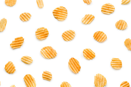 Crinkle cut potato chips isolated on white background. Tasty spicy potato chips.の写真素材