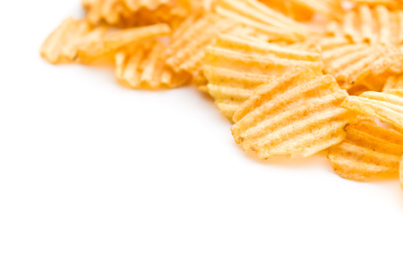 Crinkle cut potato chips isolated on white background. Tasty spicy potato chips.の写真素材