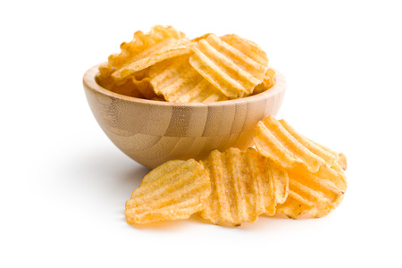 Crinkle cut potato chips isolated on white background. Tasty spicy potato chips in bowl.の写真素材