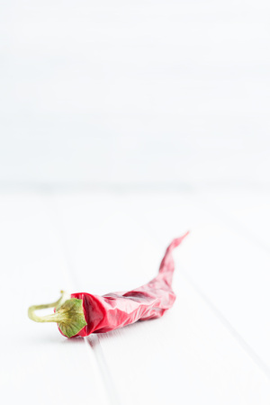 Dried chili pepper on white table.の写真素材