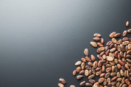 The roasted cocoa beans on black background.の写真素材