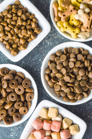 Different dog foods in bowls. Top view.の写真素材