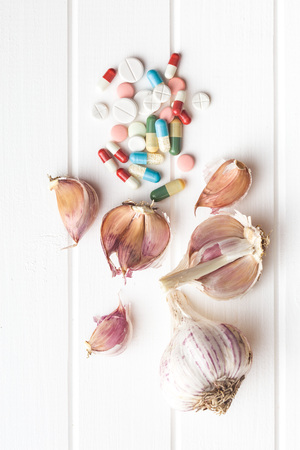 Pills and garlic. Natural antibiotics.の写真素材