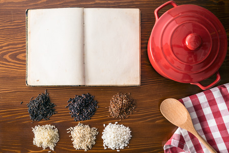 Blank cookbook and different rice varieties. Top view.の写真素材