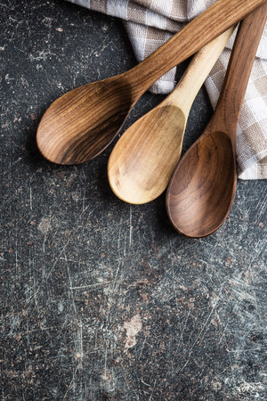 Handmade wooden spoons on old kitchen table. Top view.の写真素材