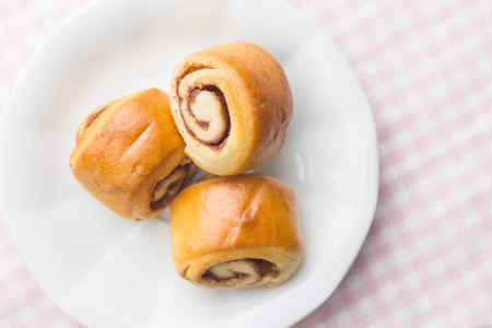 Mini cinnamon buns on plate. Top view.
