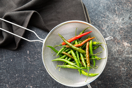 The chili peppers in colander. Top view.の写真素材