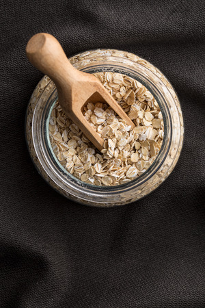 Dry rolled oatmeal in glass jar. Top view.の写真素材