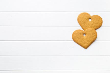 Gingerbread shape heart on white table. Top view.の写真素材