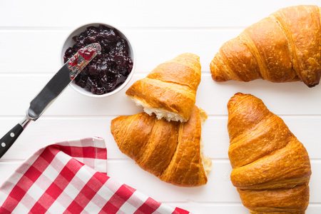 Tasty buttery croissant and jam in jar. Top view.の写真素材