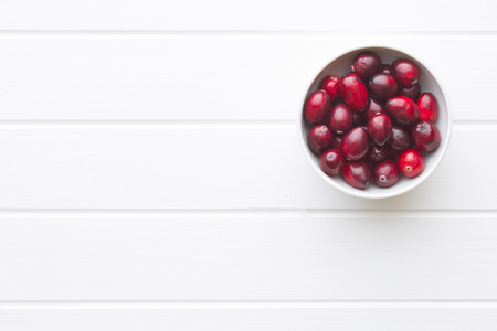 The tasty american cranberry in bowl on white table.の写真素材